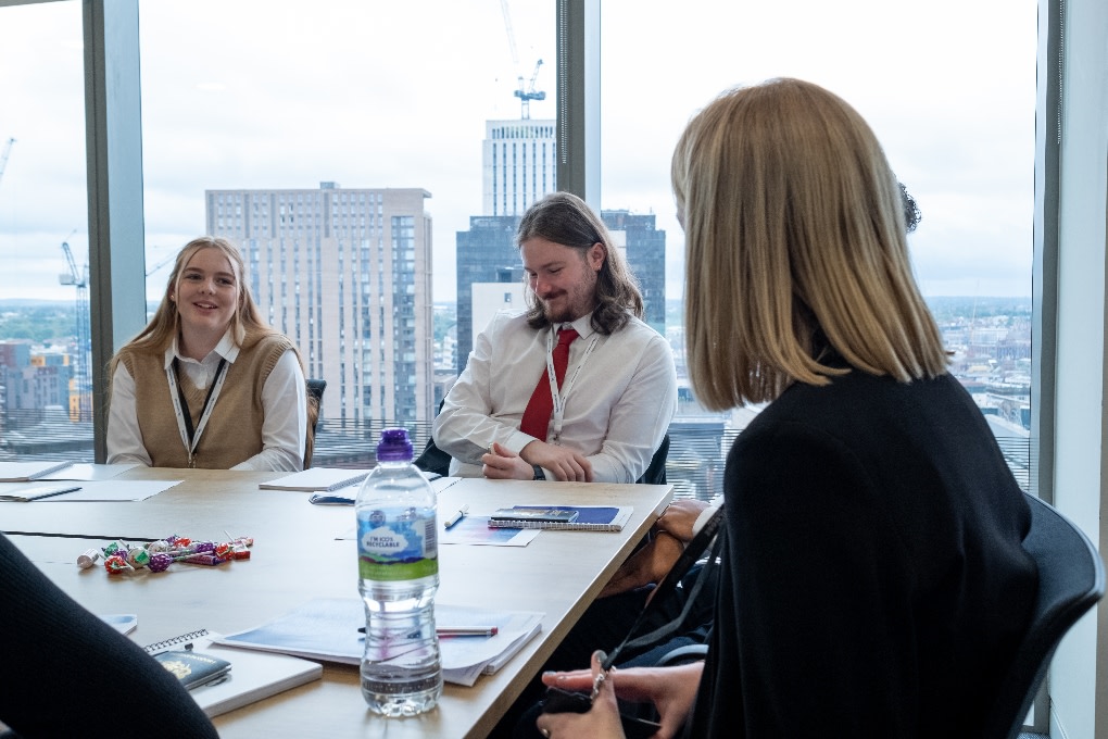 A group of apprentices in a city office sat around a conference table 